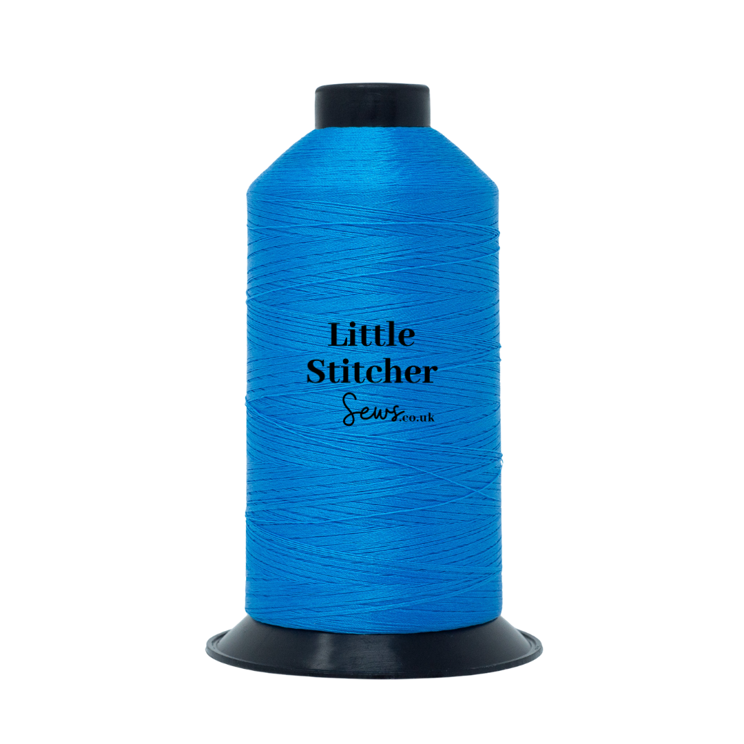Spool of azure blue thread with 'Little Stitcher Sews' branding on a white background