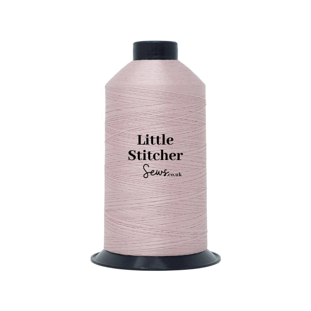 Spool of blush pink thread with 'Little Stitcher Sews' branding on a white background