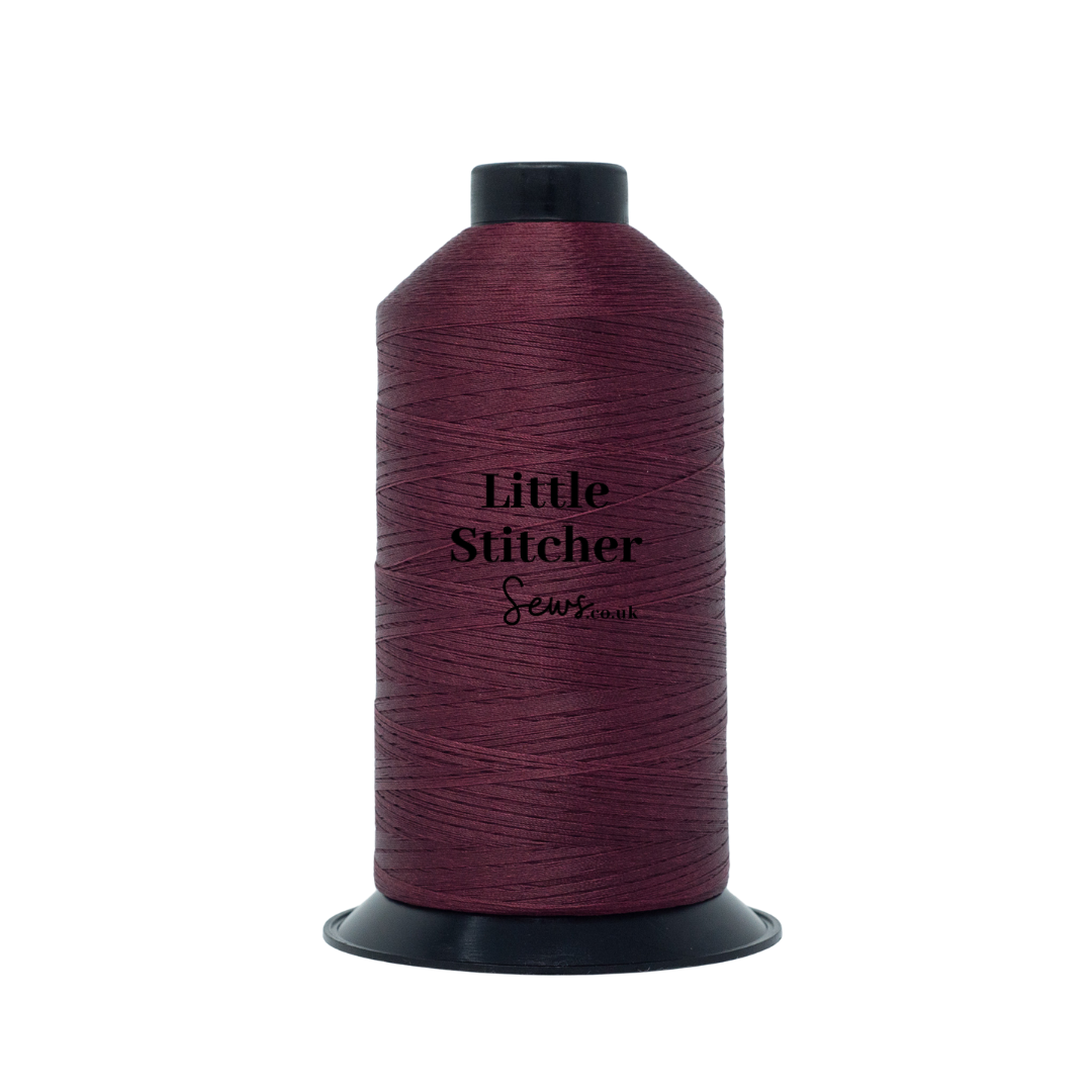 Spool of burgundy thread with 'Little Stitcher Sews' branding on a white background