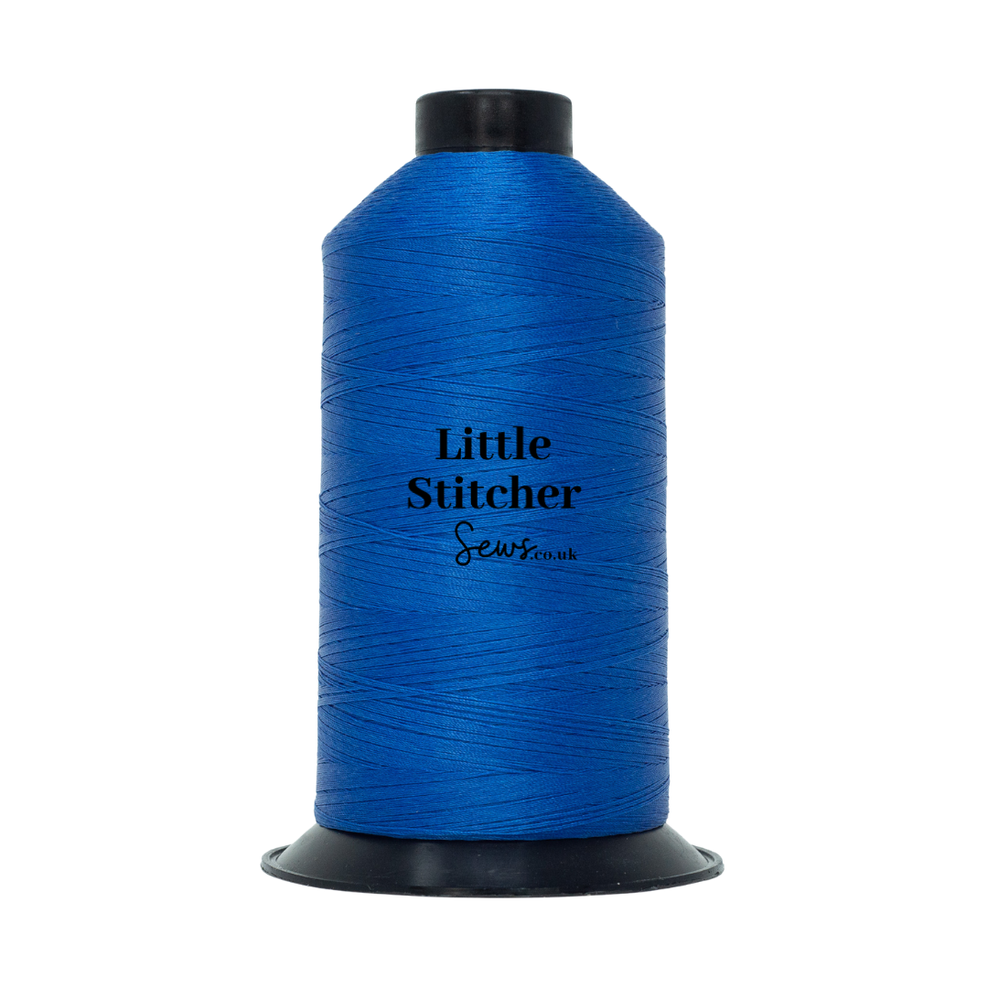 Spool of cobalt blue thread with 'Little Stitcher Sews' branding on a white background