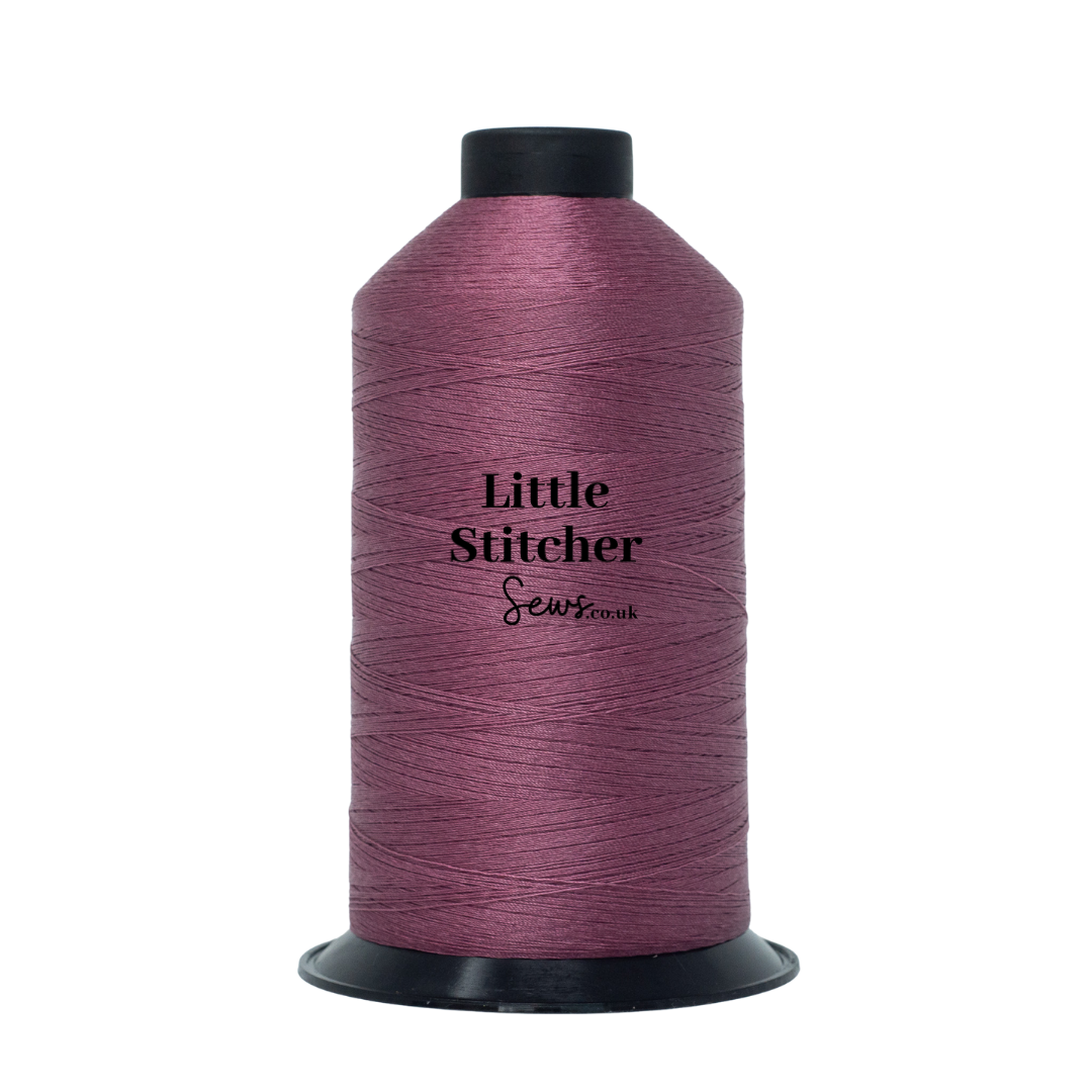 Spool of dusty rose thread with 'Little Stitcher Sews' branding on a white background
