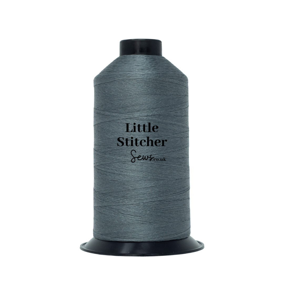 Spool of grey thread with 'Little Stitcher Sews' branding on a white background