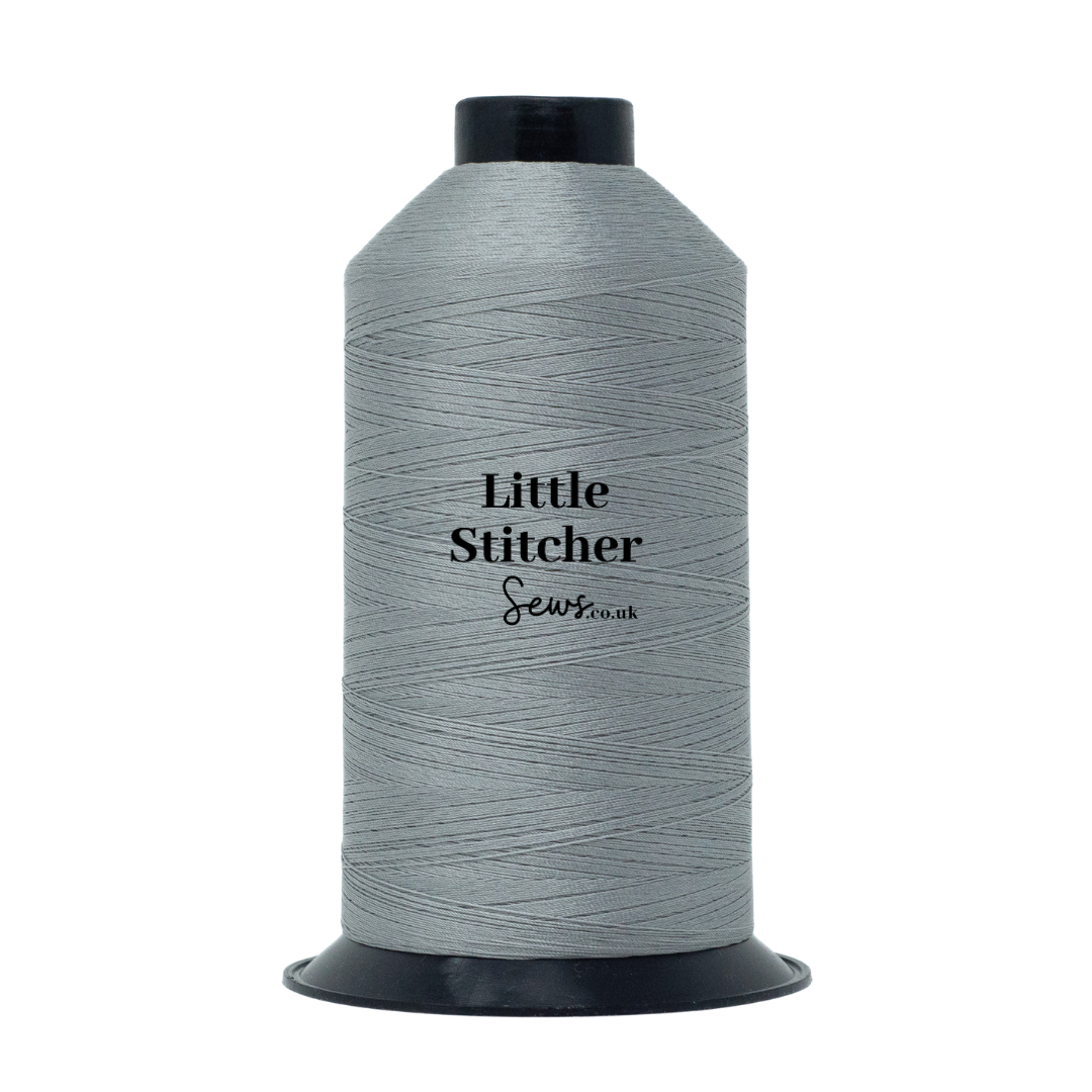 Spool of light grey thread with 'Little Stitcher Sews' branding on a white background