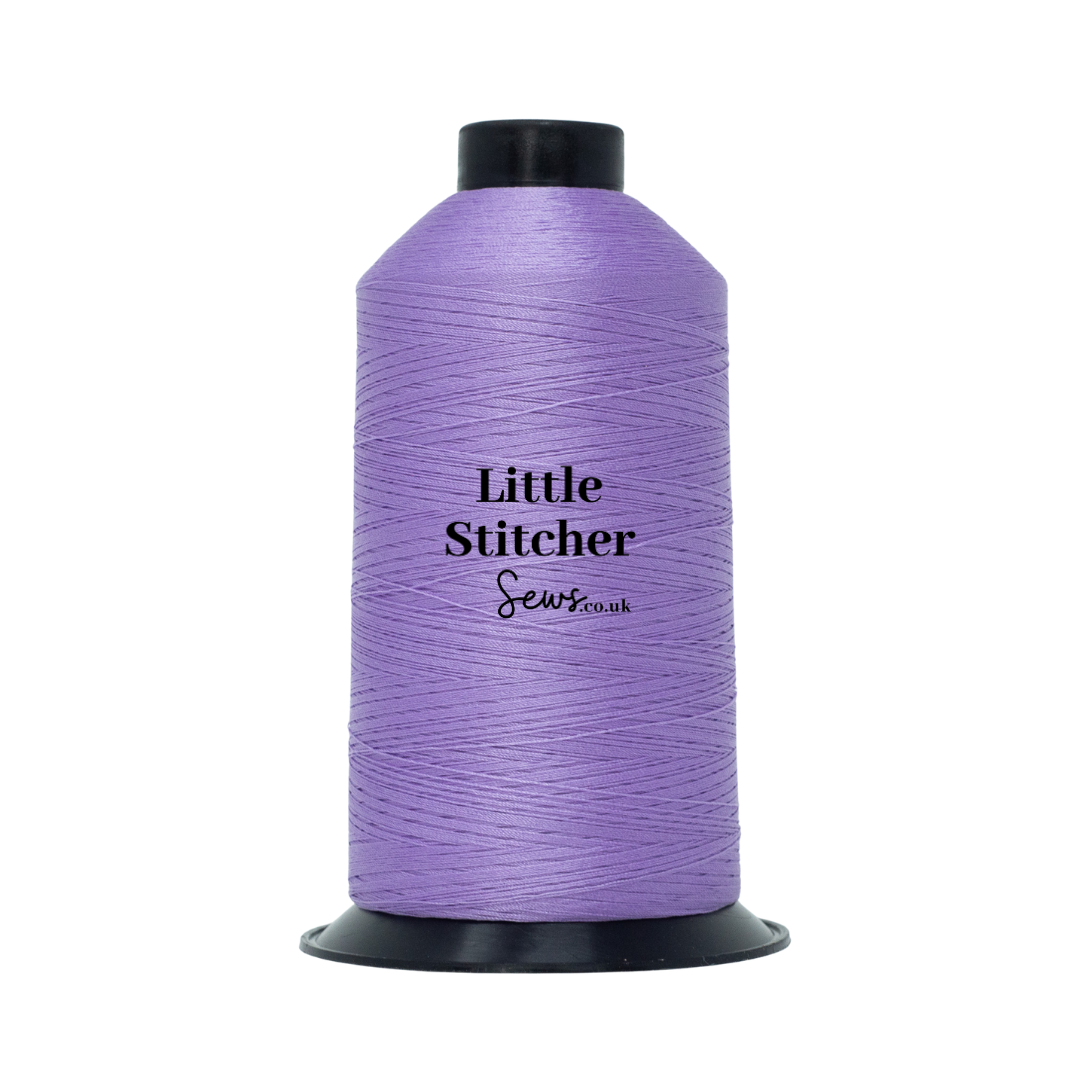 Spool of lilac thread with 'Little Stitcher Sews' branding on a white background