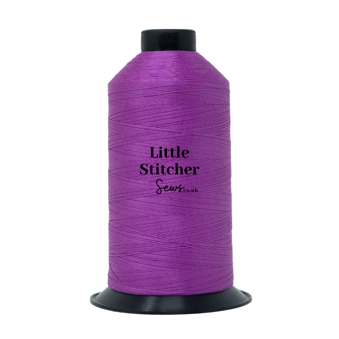 Spool of magenta thread with 'Little Stitcher Sews' branding on a white background