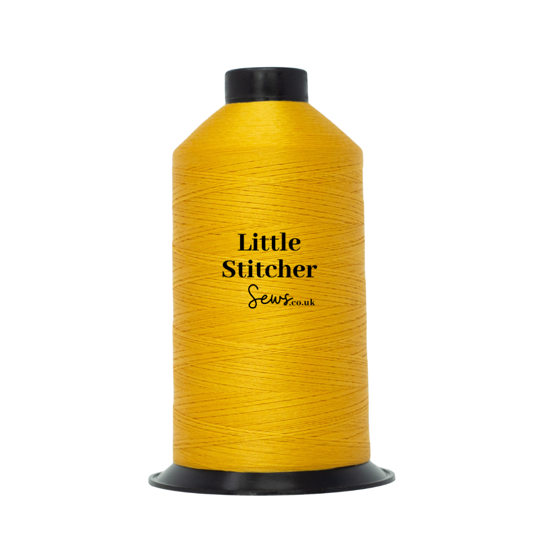 Spool of mustard thread with 'Little Stitcher Sews' branding on a white background