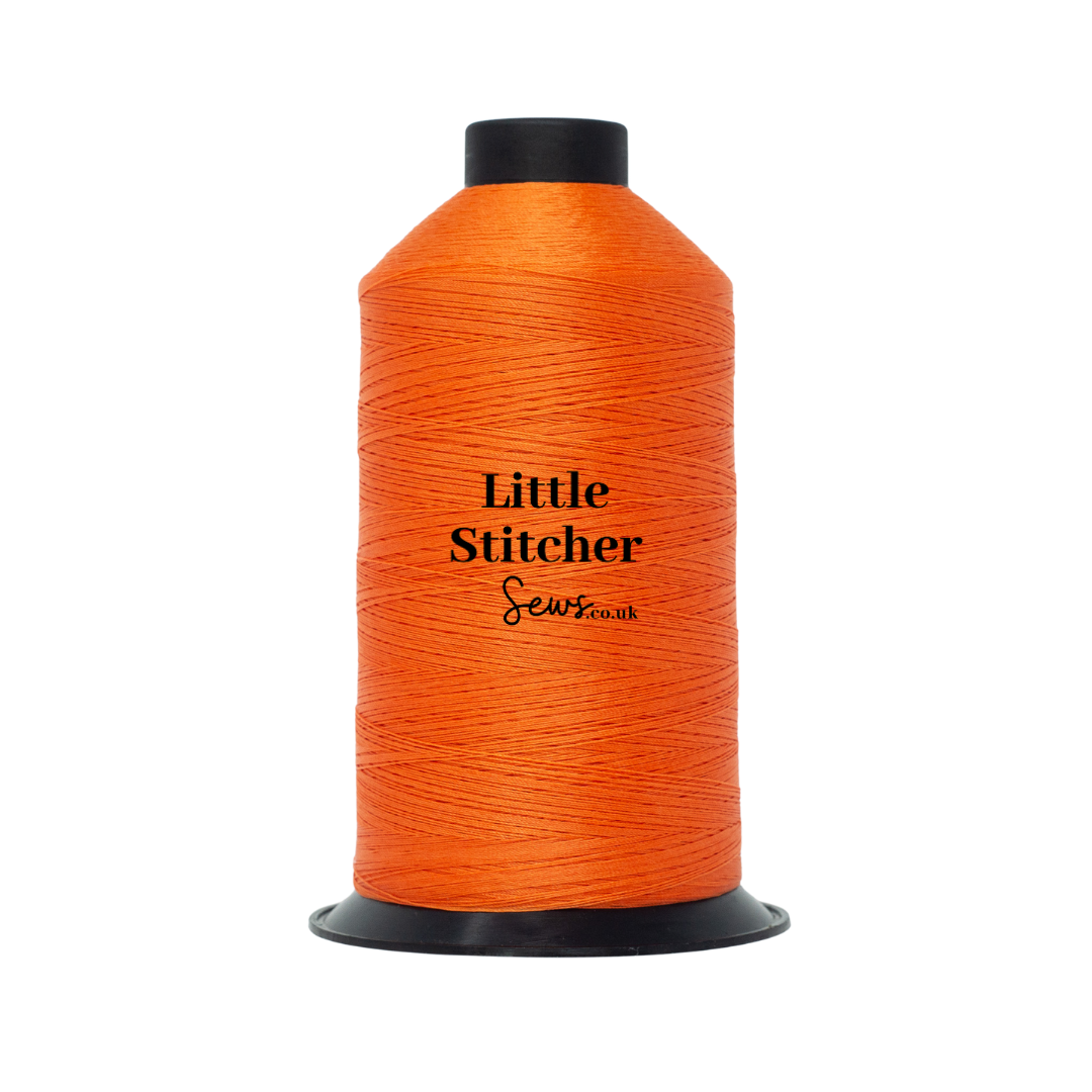 Spool of orange thread with 'Little Stitcher Sews' branding on a white background