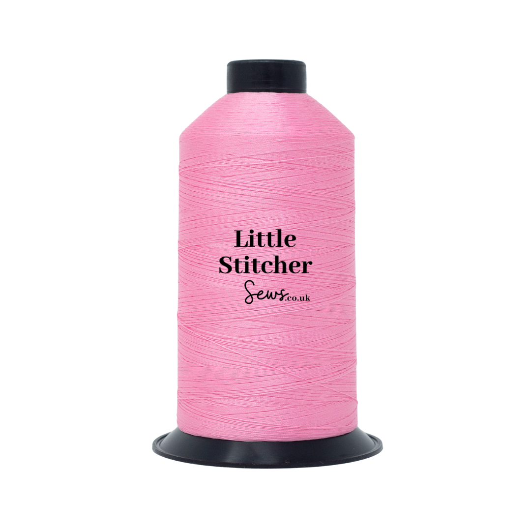 Spool of pink thread with 'Little Stitcher Sews' branding on a white background