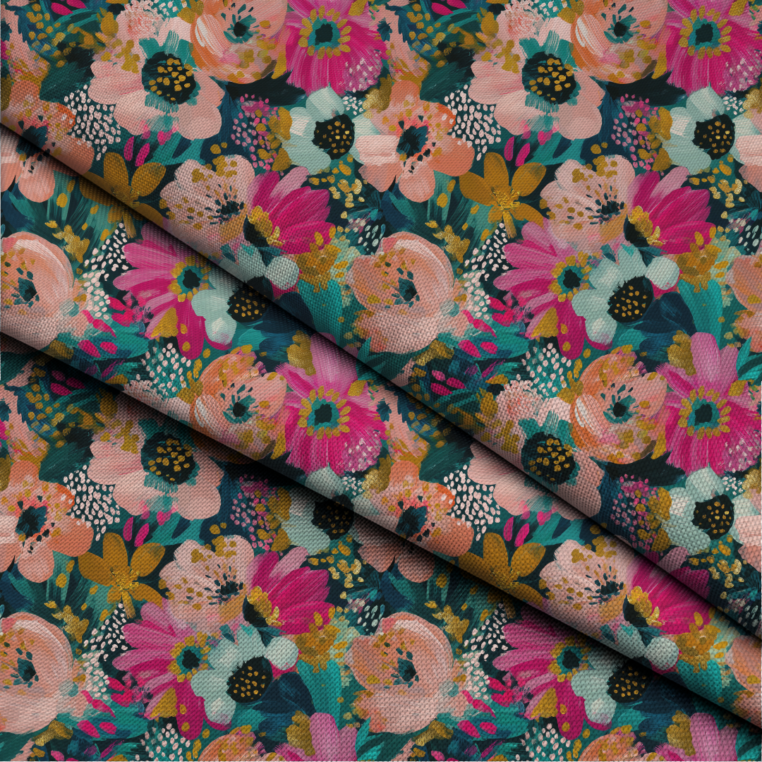 A close-up of a folded piece of fabric with a dense floral print. The pattern features large flowers in vibrant pink, peach, and mustard yellow with dark green and teal leaves on a dark teal background.