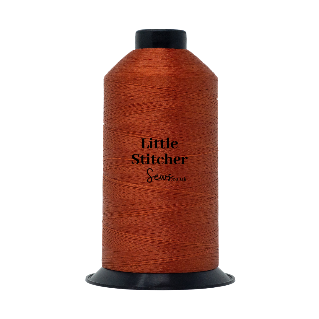 Spool of rust thread with 'Little Stitcher Sews' branding on a white background