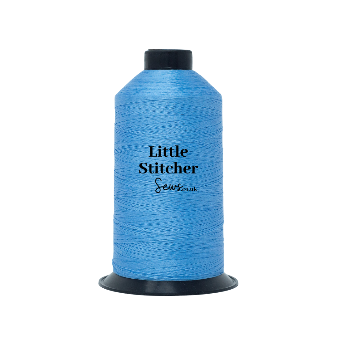 Spool of sky blue thread with 'Little Stitcher Sews' branding on a white background