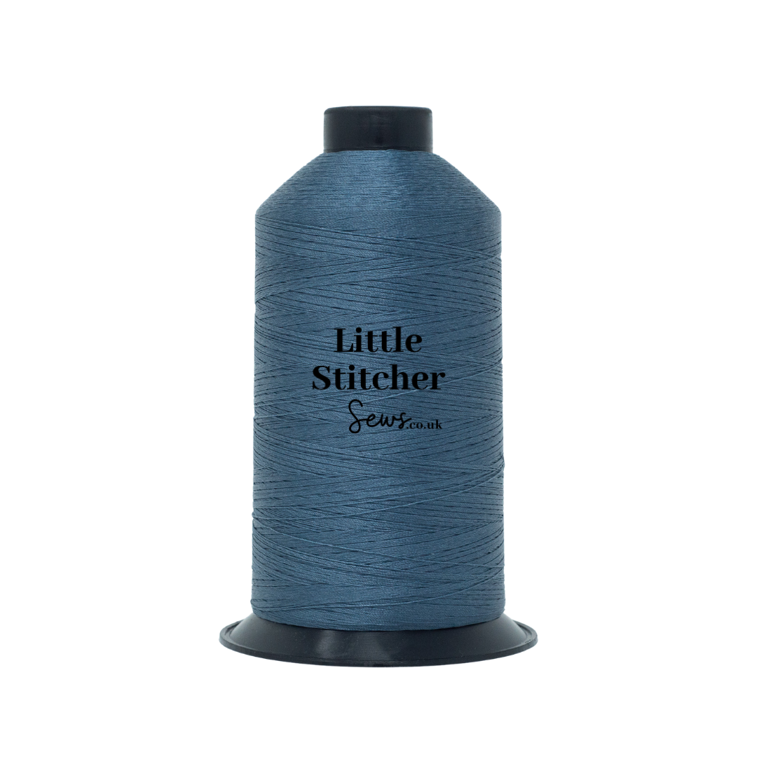 Spool of slate blue thread with 'Little Stitcher Sews' branding on a white background