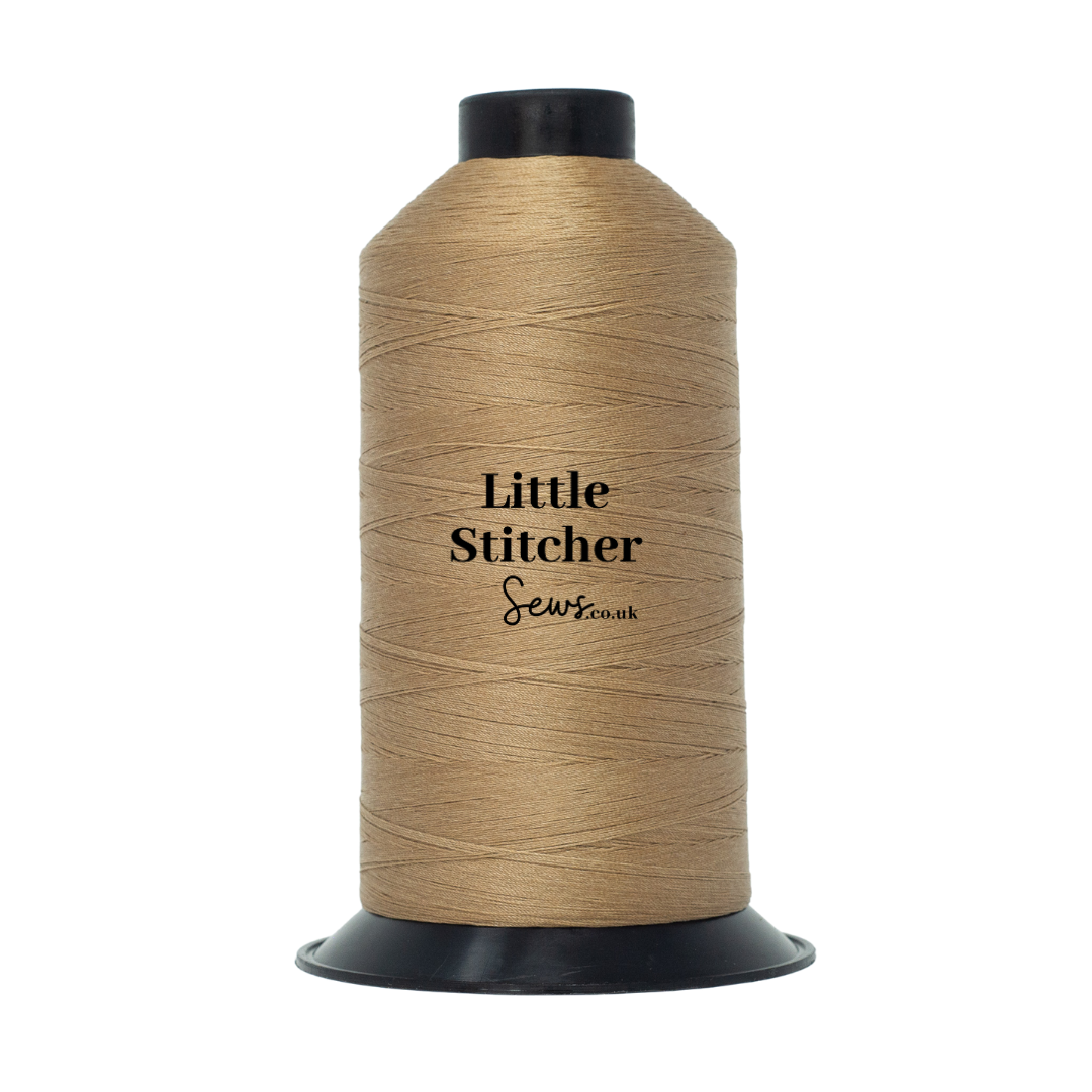 Spool of tan thread with 'Little Stitcher Sews' branding on a white background