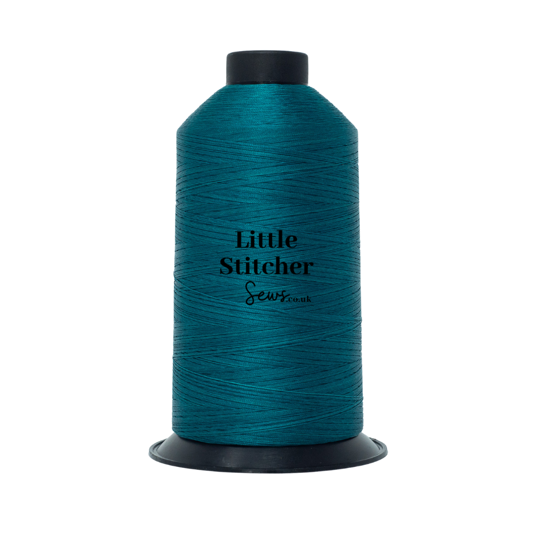 Spool of teal thread with 'Little Stitcher Sews' branding on a white background