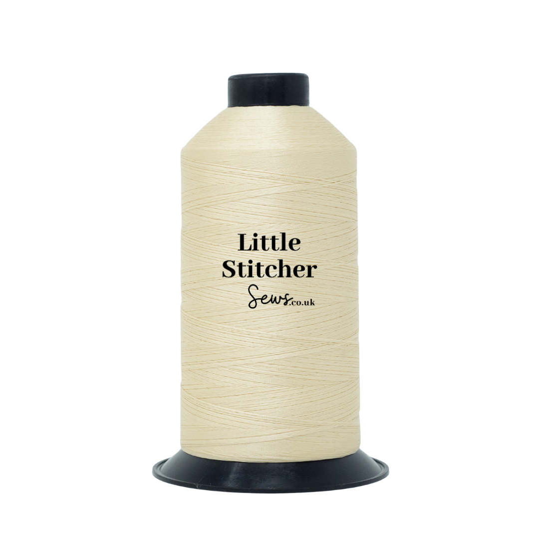 Spool of cream thread with 'Little Stitcher Sews' branding on a white background