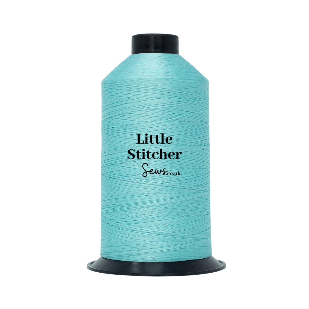 Spool of mint thread with 'Little Stitcher Sews' branding on a white background