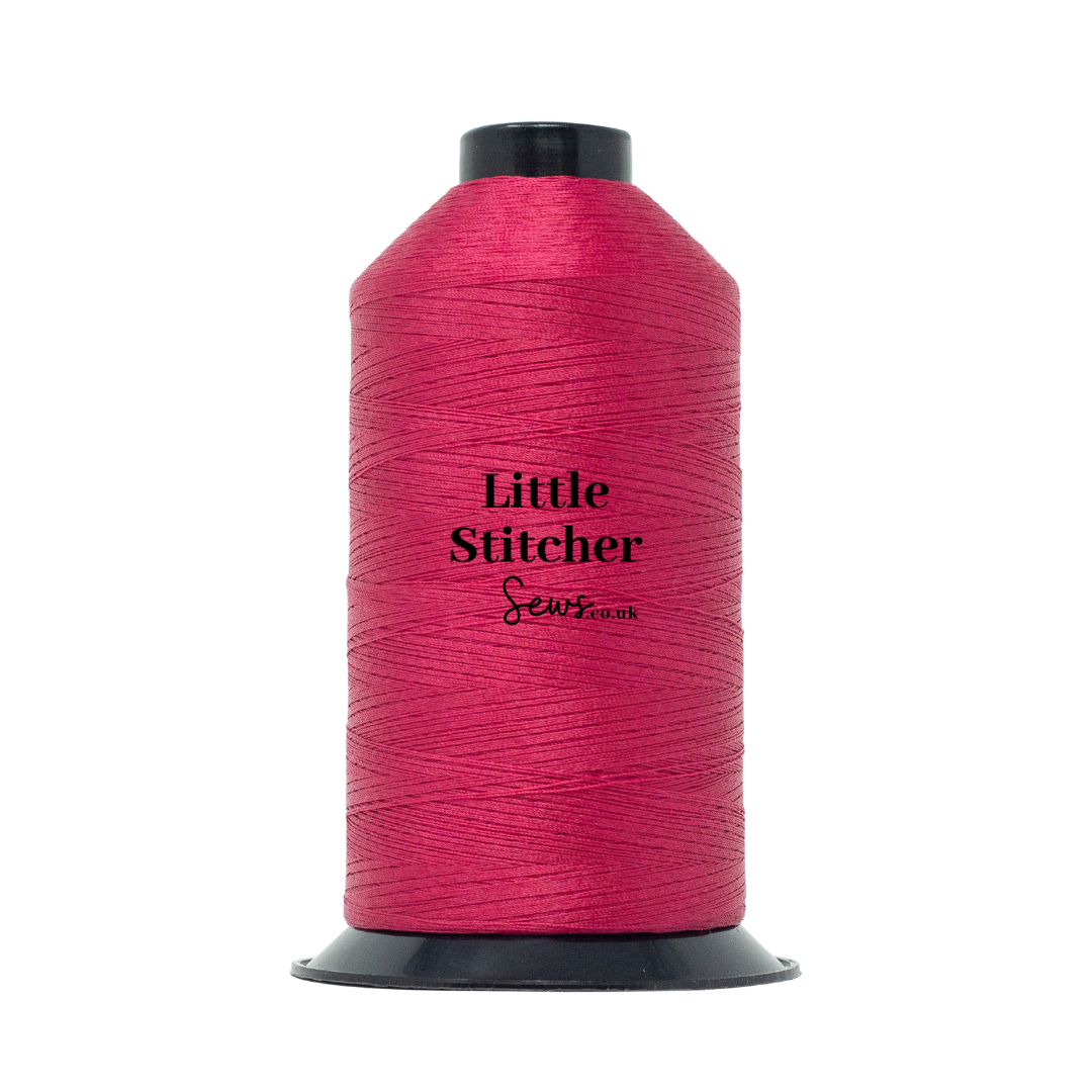 Spool of raspberry thread with 'Little Stitcher Sews' branding on a white background