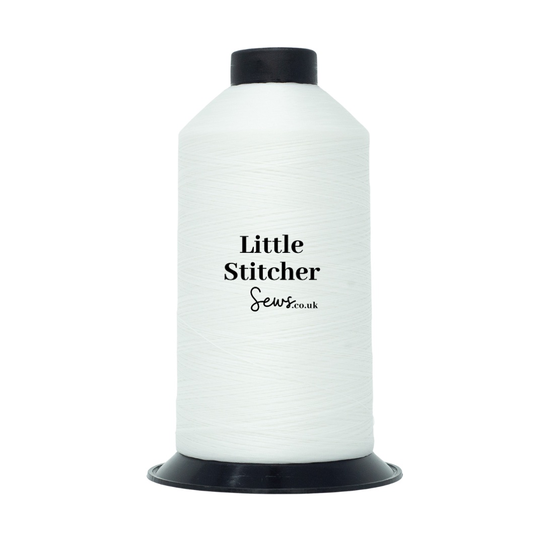 Spool of white thread with 'Little Stitcher Sews' branding on a white background